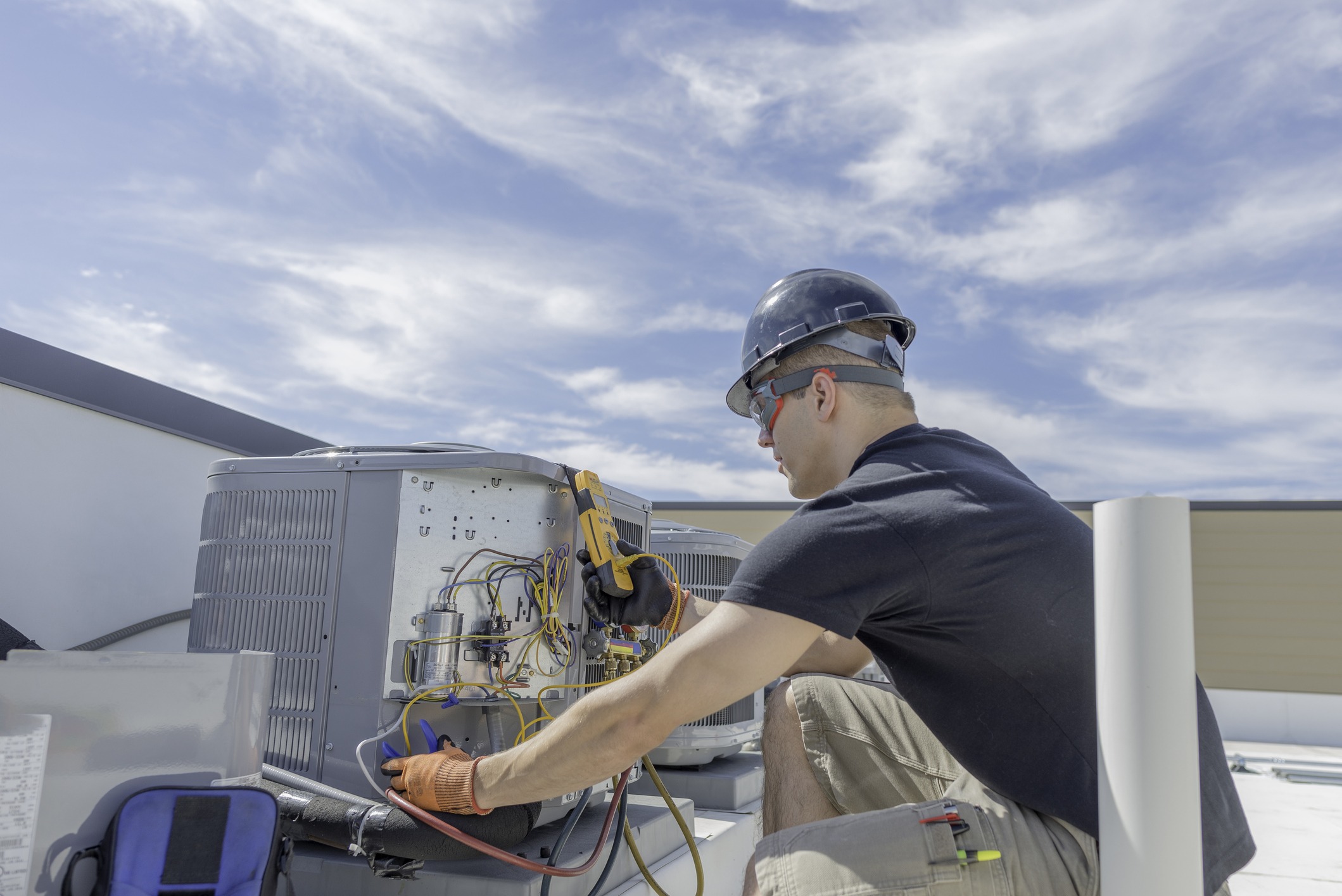 HVAC tech working on condenser